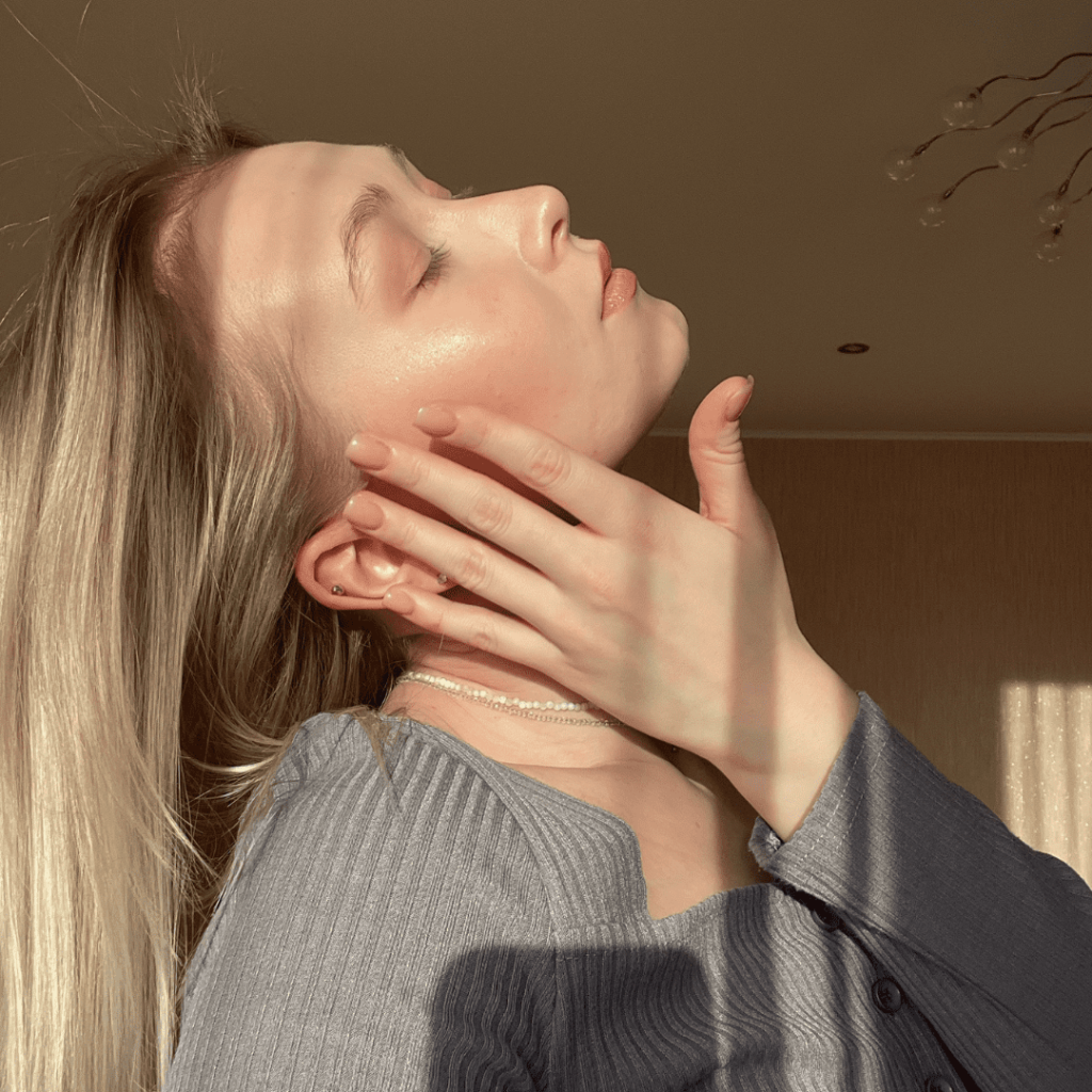 Woman slightly touching her face with her hand