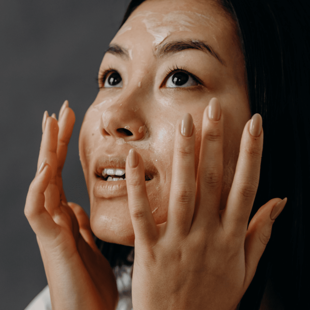 Person with dry skin carefully touching their face