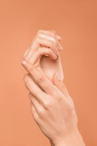 hands of a person on an orange background